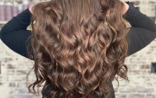 girl with brown hair who had hair extensions installed at salons near me