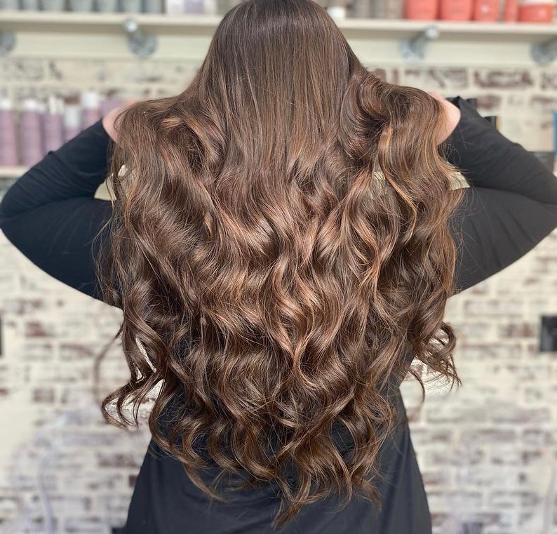 girl with brown hair who had hair extensions installed at salons near me